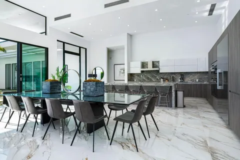a view of a dining room and hall with furniture