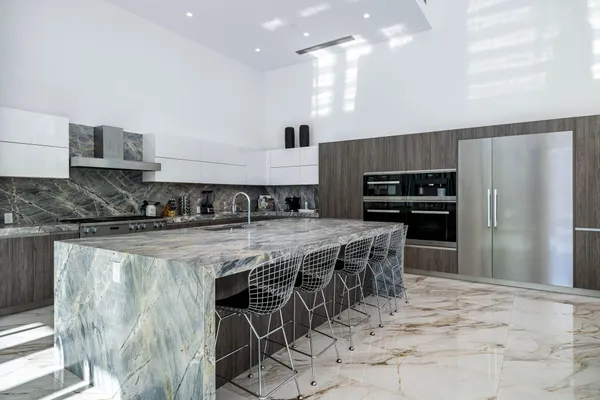 a dining room with furniture and a floor to ceiling window