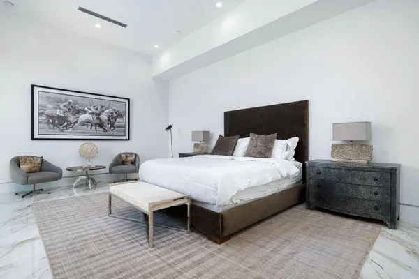 a bed room with a bed and chair