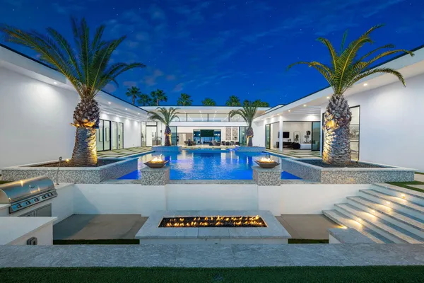 a open kitchen with stainless steel appliances granite countertop a stove a sink and a microwave