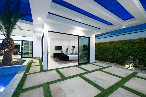 a bedroom with a bed and a view of pool