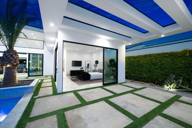 a bedroom with a bed and a view of pool