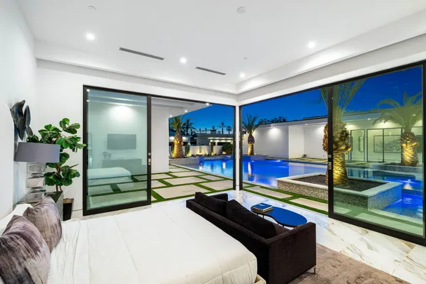 a view of pool fire place and outdoor kitchen view