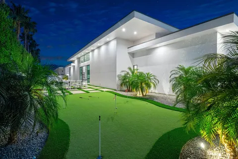 a front view of a house with a yard and trees