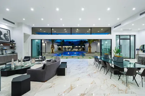 a view of living room with furniture and large windows