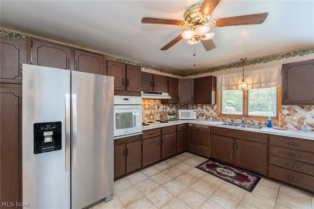 2170 Norton Road Stow, OH 44224 - Photo 30 of 48 Kitchen featuring wood cabinetry, light countertops, a built-in oven, stainless steel side-by-side refrigerator, and tile flooring