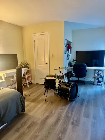 a living room with furniture and a wooden floor