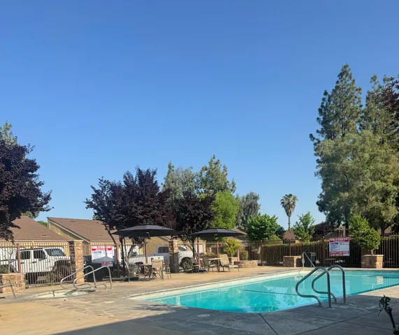 a view of outdoor space with seating area and trees around