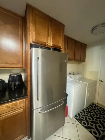 a kitchen with a refrigerator and cabinets