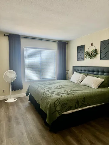 a bedroom with a bed and window