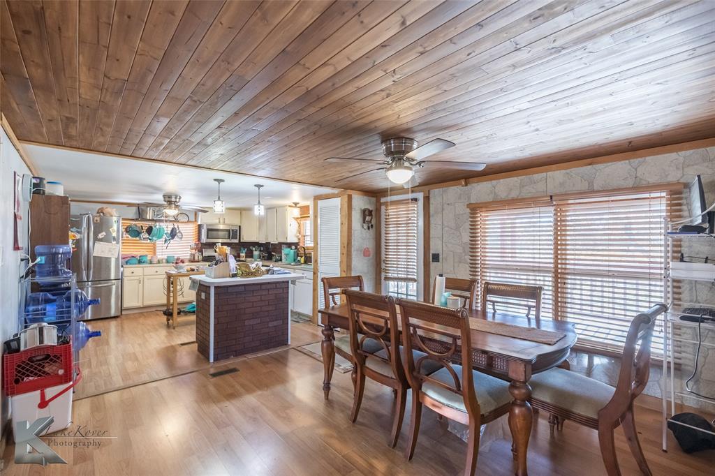 10001 County Road 379 Hawley, TX 79525 - Photo 15 of 39 a room with lots of wooden furniture and large windows