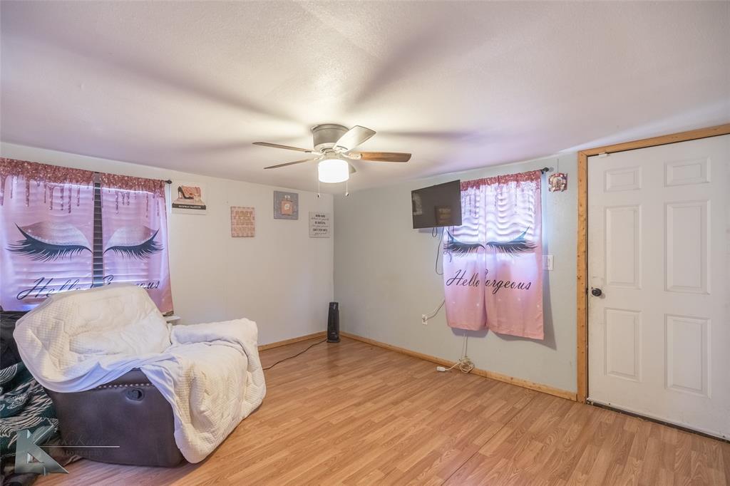 10001 County Road 379 Hawley, TX 79525 - Photo 27 of 39 a bedroom with a bed and wooden floor