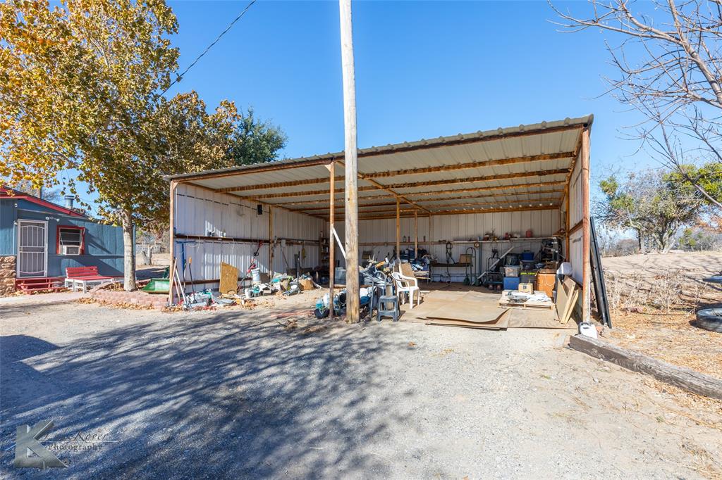 10001 County Road 379 Hawley, TX 79525 - Photo 39 of 39 a view of a patio with a table and chairs under an umbrella