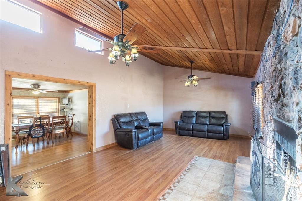 10001 County Road 379 Hawley, TX 79525 - Photo 10 of 39 a living room with furniture and a chandelier