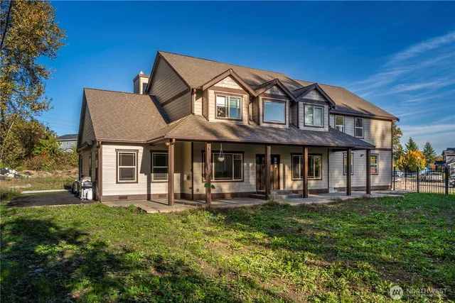 a front view of a house with a yard table and chairs