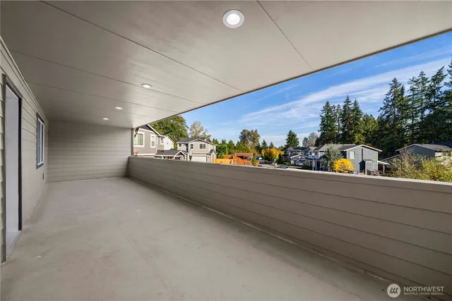a view of a hallway with wooden floor and closet
