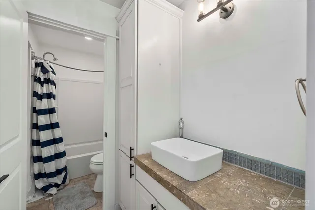 a bathroom with a sink vanity and mirror