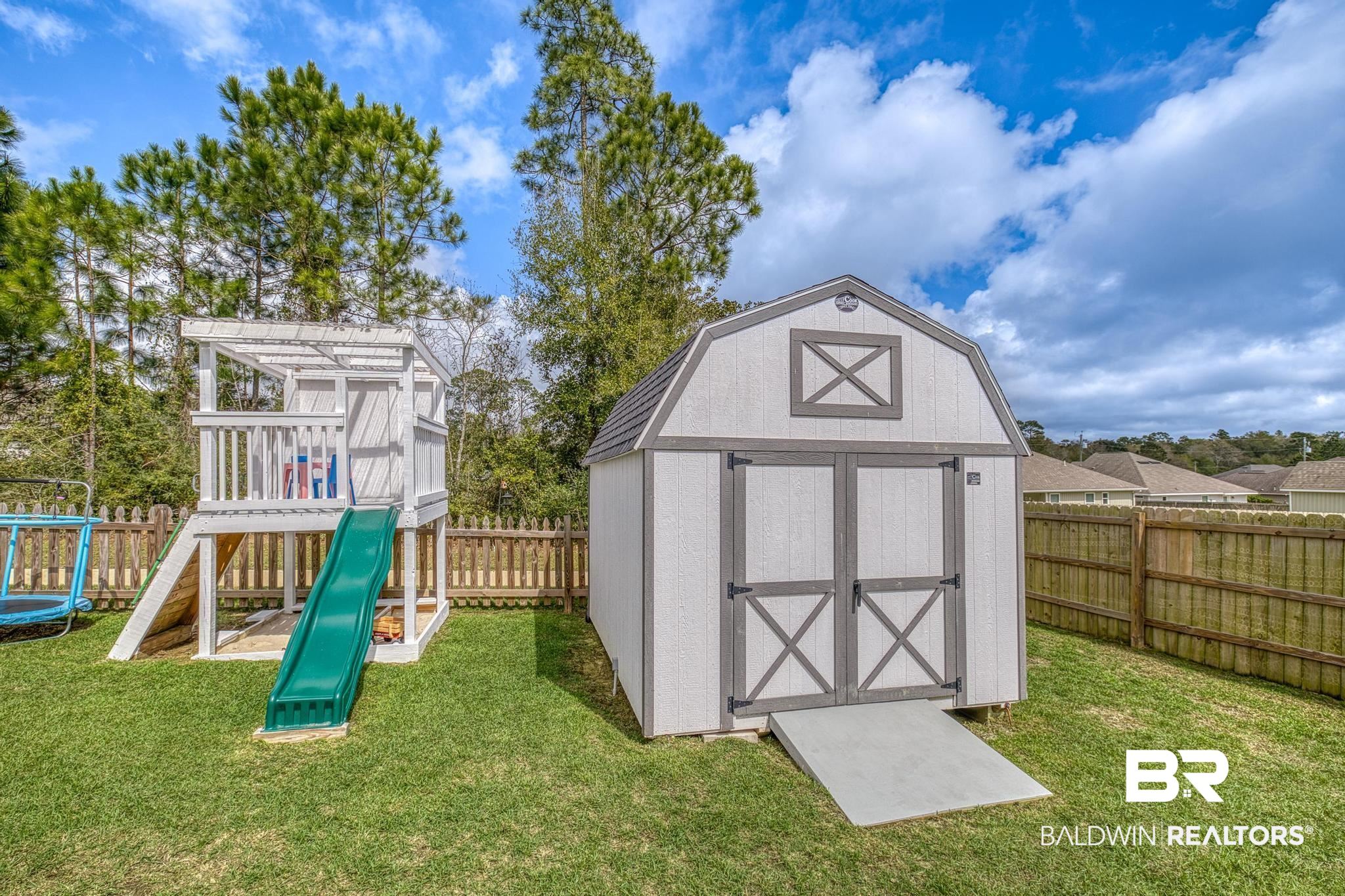 3078 Camino Real Loop Lillian, AL 36549 - Photo 28 of 51 View of shed with a fenced backyard and a playground