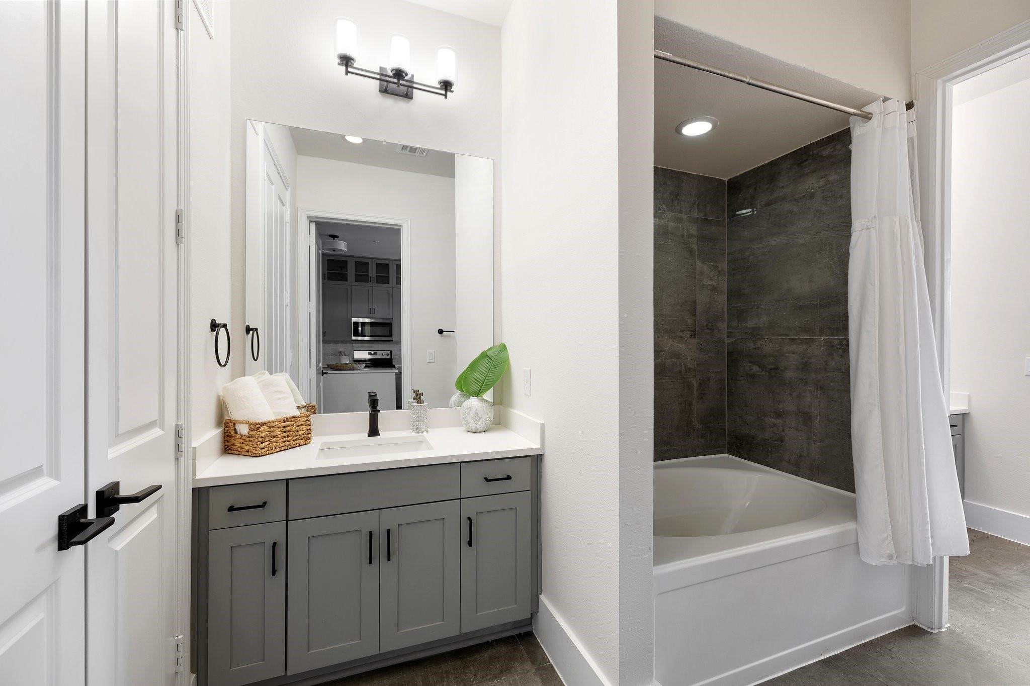 1508 Blodgett Street, Unit 503 Houston, TX 77004 - Photo 5 of 14 a bathroom with a tub sink and mirror