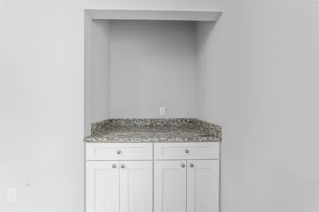 a bathroom with a granite countertop sink and vanity