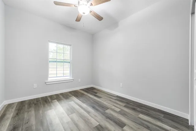 a view of a room with wooden floor and window