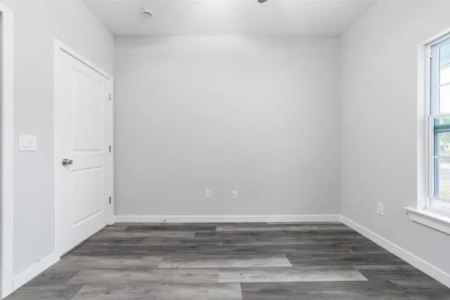 a view of a room with wooden floor