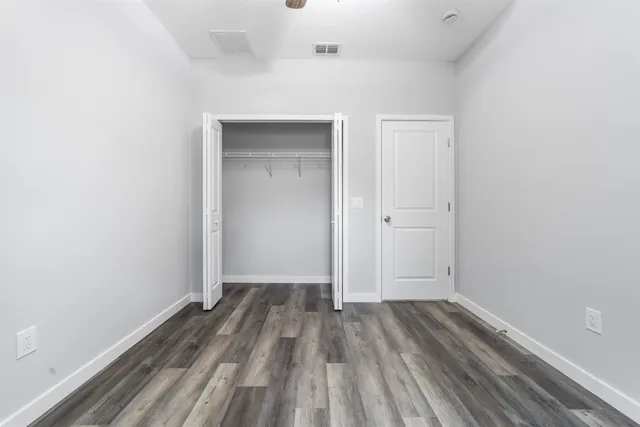 a bathroom with a granite countertop sink a toilet and bathtub