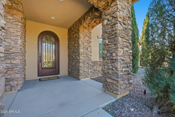 a bedroom with a bed a chandelier and a window