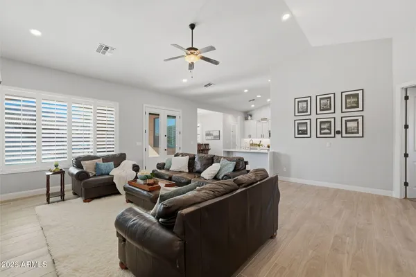 a bedroom with a bed and a lamp on dresser