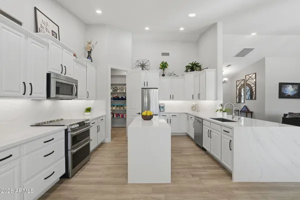 a living room with furniture and a view of kitchen