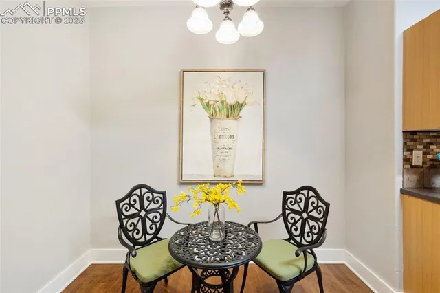 a view of a dining room with furniture and a potted plant