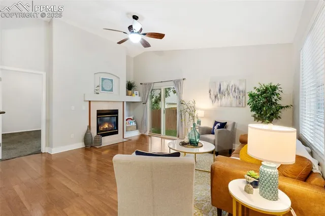 a living room with furniture a fireplace and a potted plant