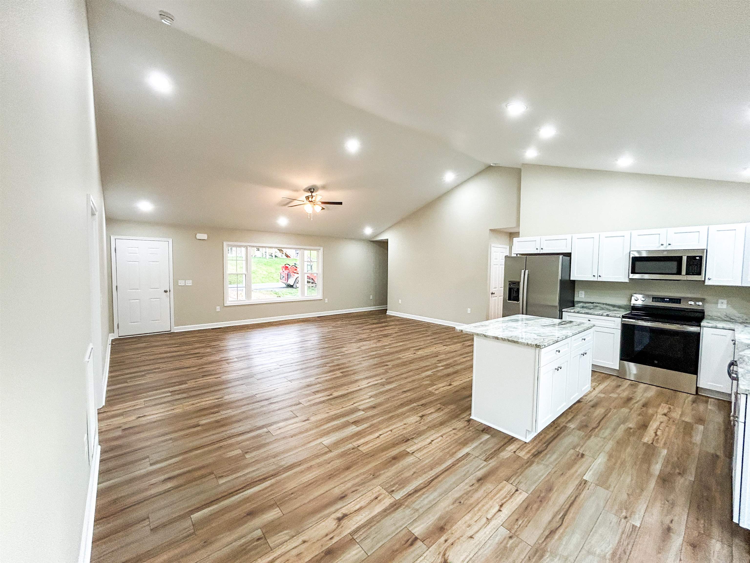 244 Locustdale Loop Shenandoah, VA 22849 - Photo 19 of 74 a kitchen with stainless steel appliances kitchen island granite countertop a stove a sink and a refrigerator