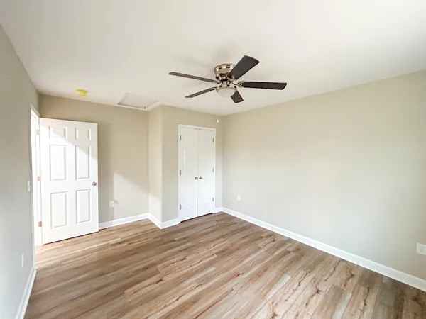 a view of empty room with wooden floor