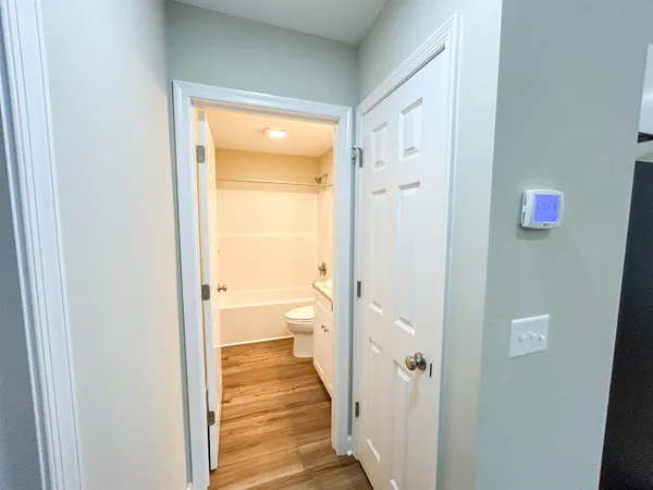 a view of a room with wooden floor