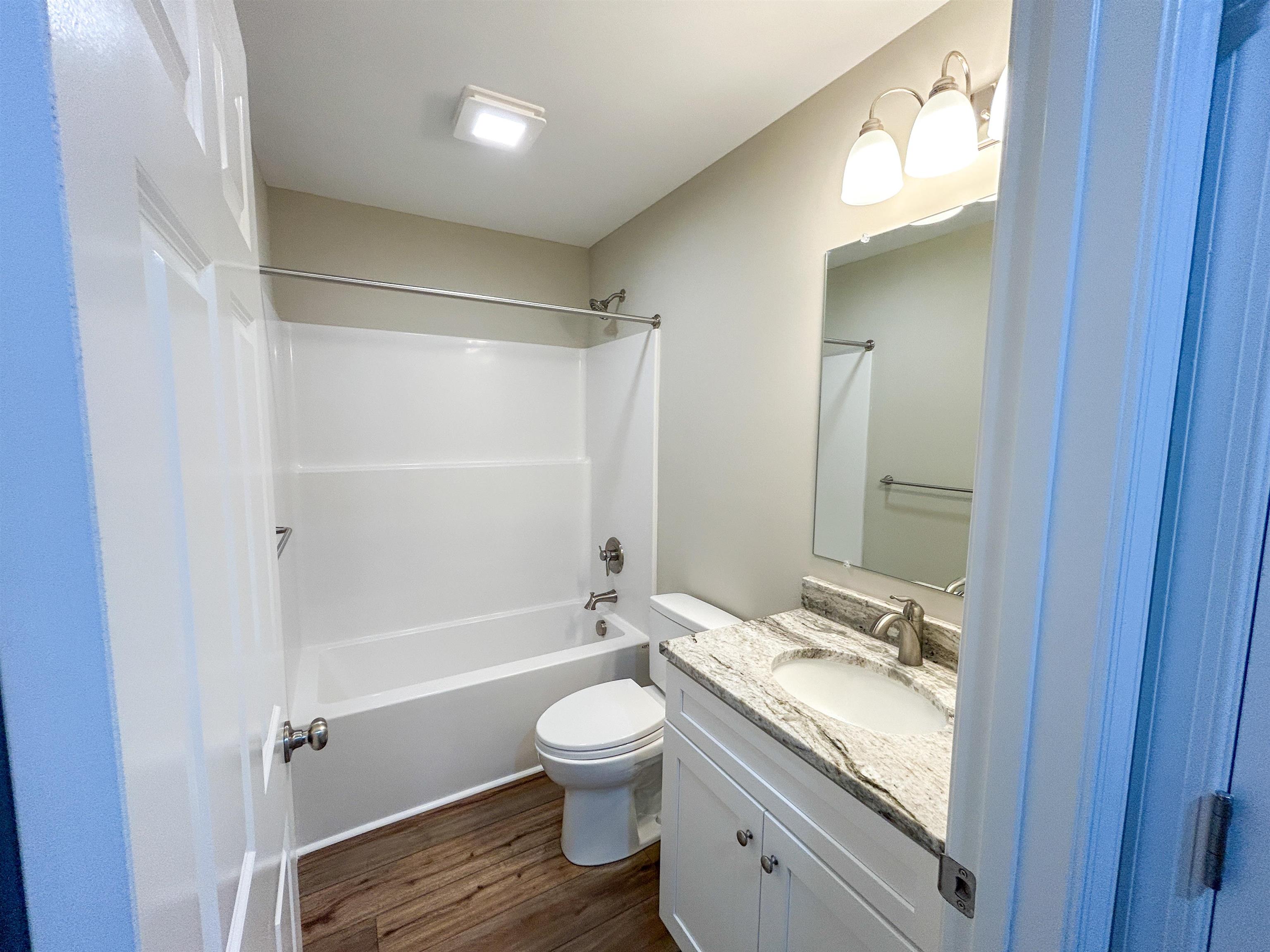 244 Locustdale Loop Shenandoah, VA 22849 - Photo 31 of 74 a bathroom with a granite countertop toilet a sink and a mirror
