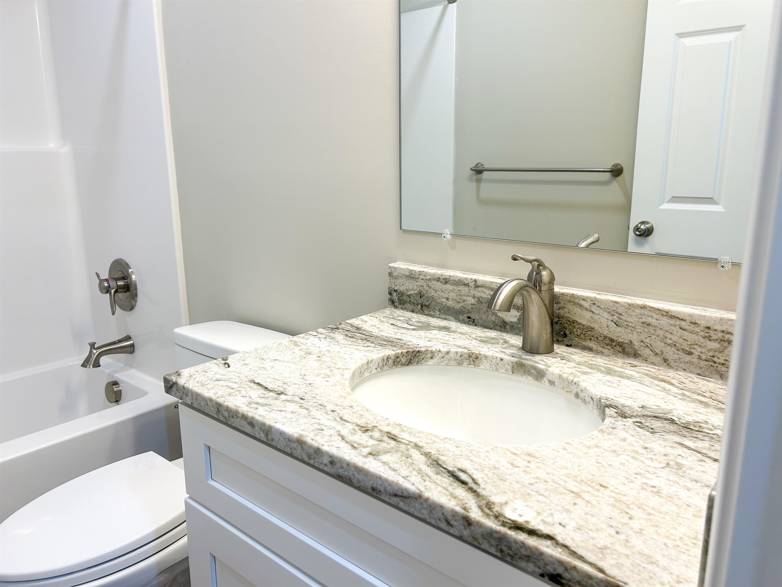 244 Locustdale Loop Shenandoah, VA 22849 - Photo 32 of 74 a bathroom with a granite countertop sink a toilet and bathtub