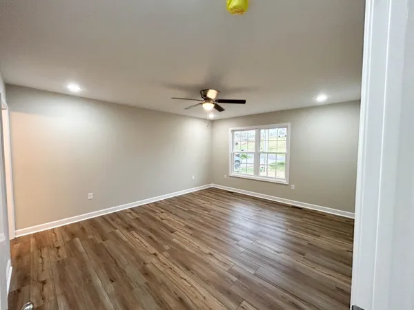 a view of balcony with wooden floor and fence