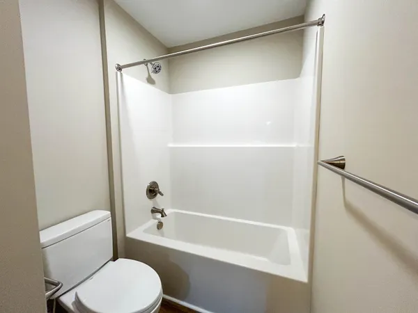 a view of empty room with wooden floor and floor to ceiling window
