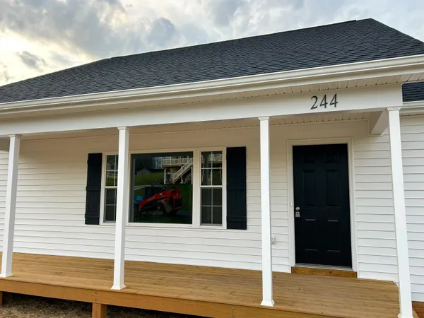 an empty room with wooden floor and window