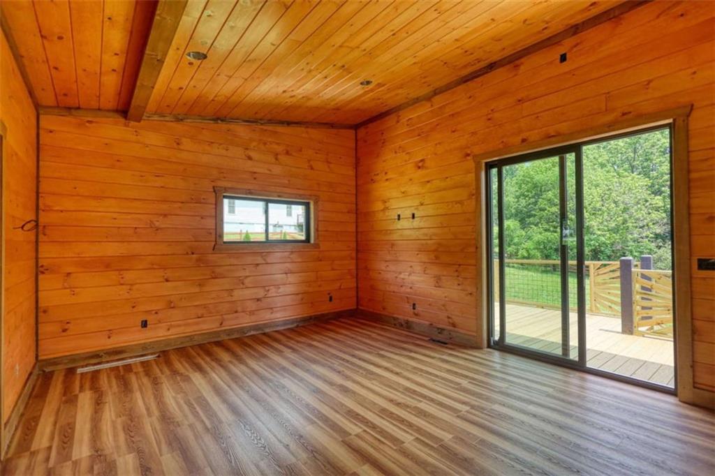 485 Church Street Blue Ridge, GA 30513 - Photo 74 of 85 a view of an empty room with wooden floor and a window