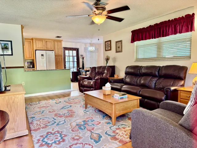 a kitchen with granite countertop a refrigerator stove top oven and sink