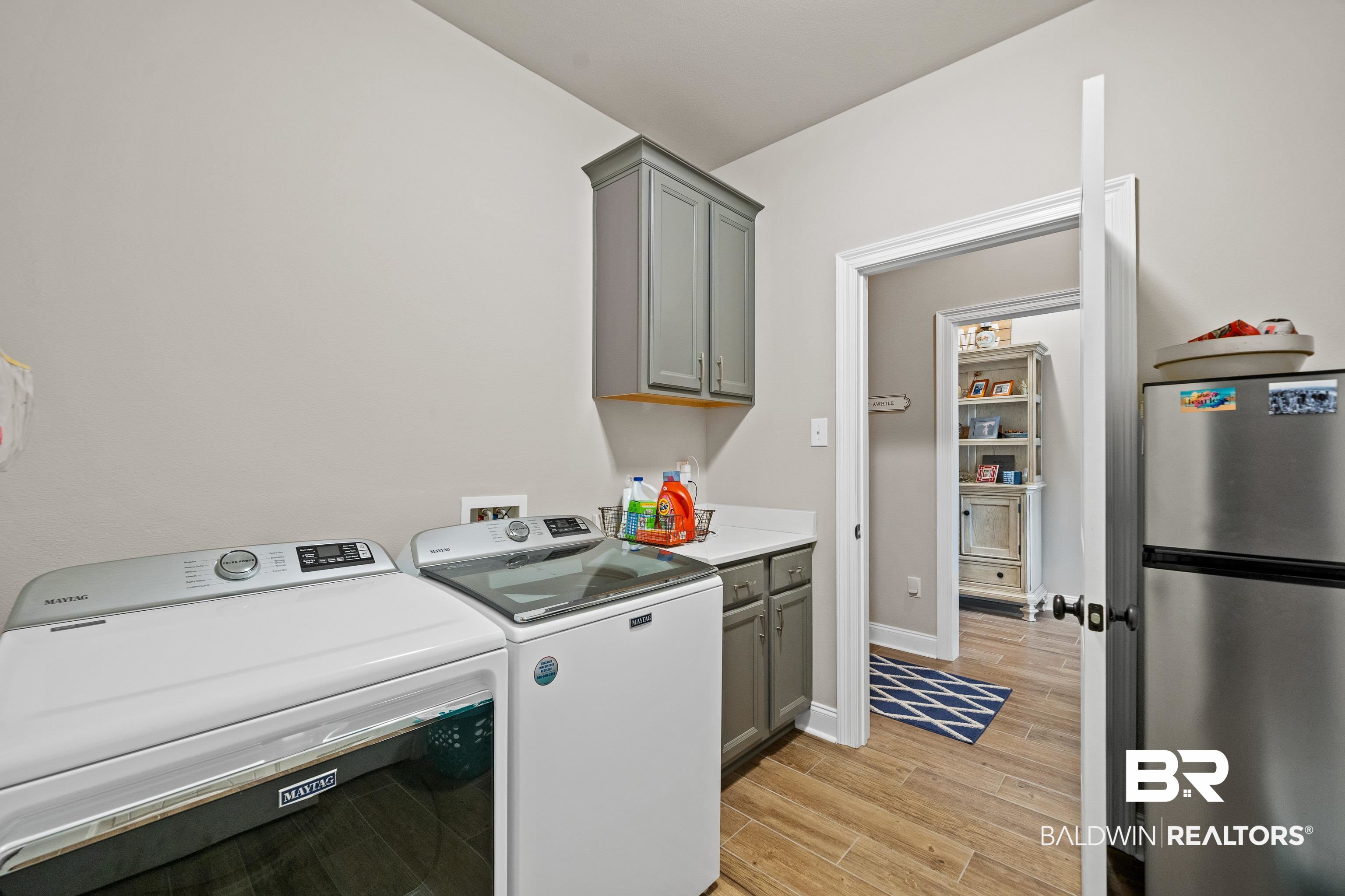 1390 Aldon Street Foley, AL 36535 - Photo 11 of 31 Laundry room featuring light wood-type flooring, cabinet space, and separate washer and dryer