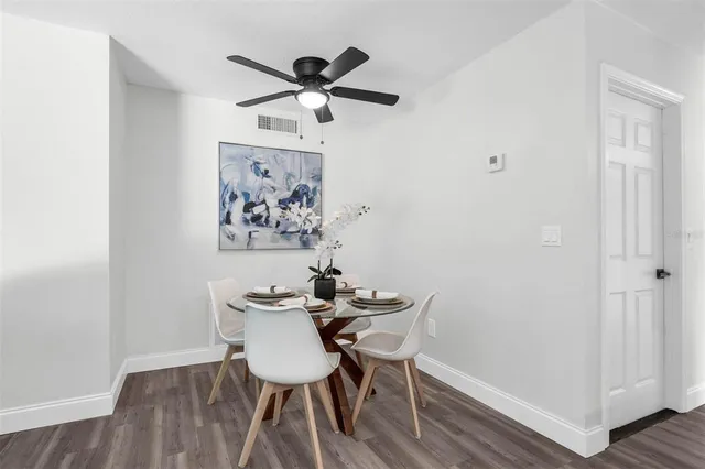 a view of a workspace with furniture and wooden floor