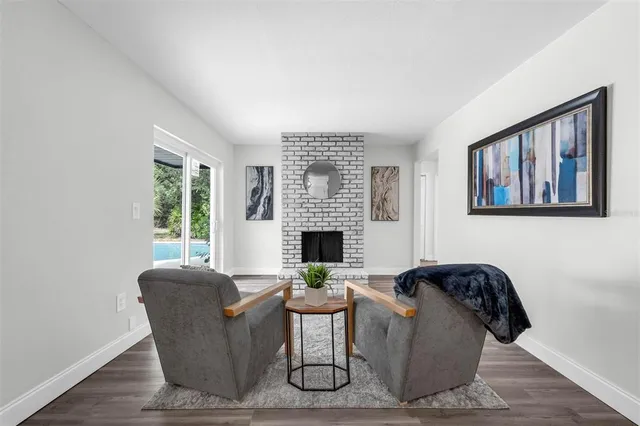 a living room with furniture fireplace and window