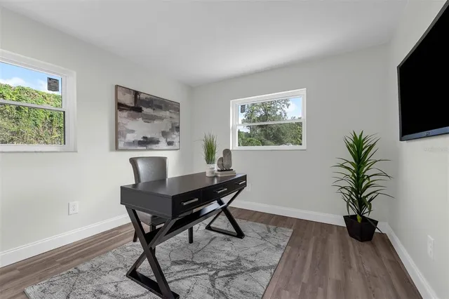 a workspace with furniture and a potted plant