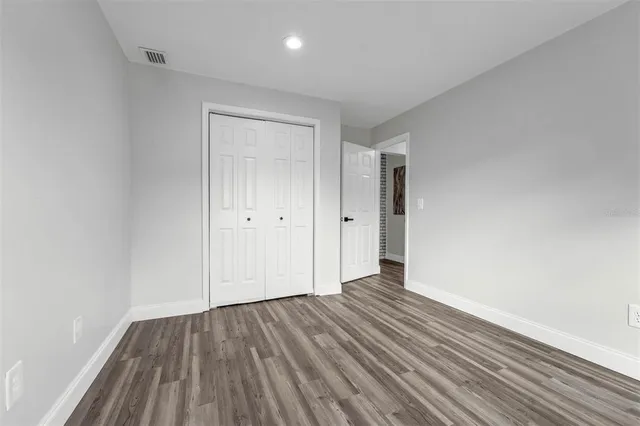 a view of an empty room and wooden floor