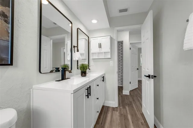 a bathroom with a double vanity sink and mirror