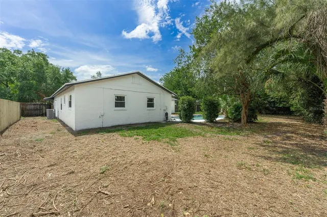 a view of backyard of house with green space