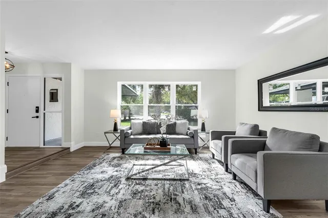 a living room with furniture window and wooden floor